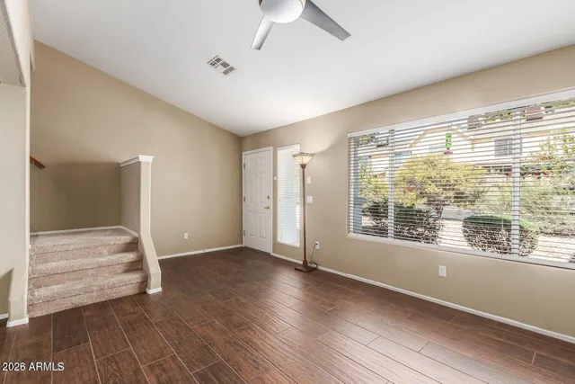 a view of wooden floor and windows in a room