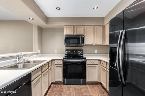 a kitchen with a sink stove and refrigerator