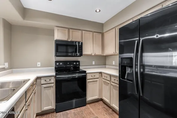 a kitchen with a refrigerator stove and microwave