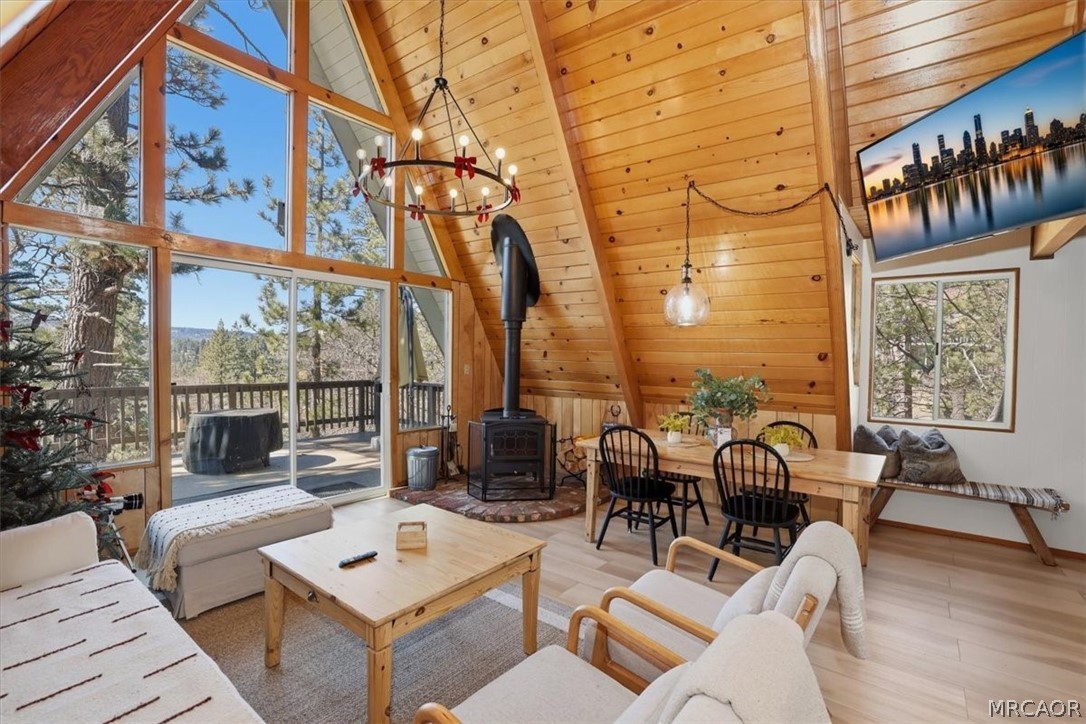 1146 Ridge Road Fawnskin, CA 92333 - Photo 1 of 34 a view of a patio with couches table and chairs and wooden floor