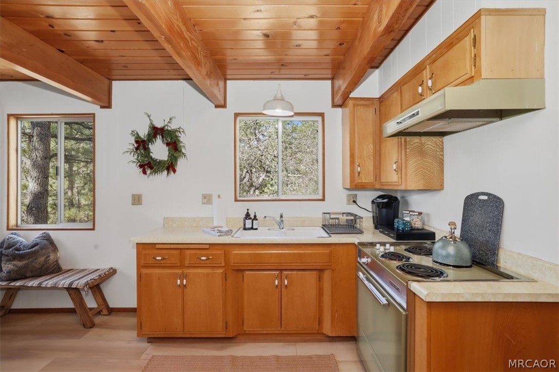 1146 Ridge Road Fawnskin, CA 92333 - Photo 12 of 34 a kitchen with stainless steel appliances granite countertop a sink stove and cabinets