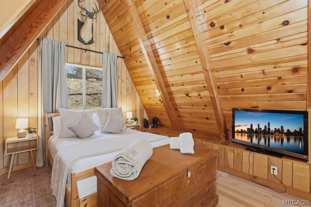 1146 Ridge Road Fawnskin, CA 92333 - Photo 17 of 34 a bedroom with furniture and a fireplace