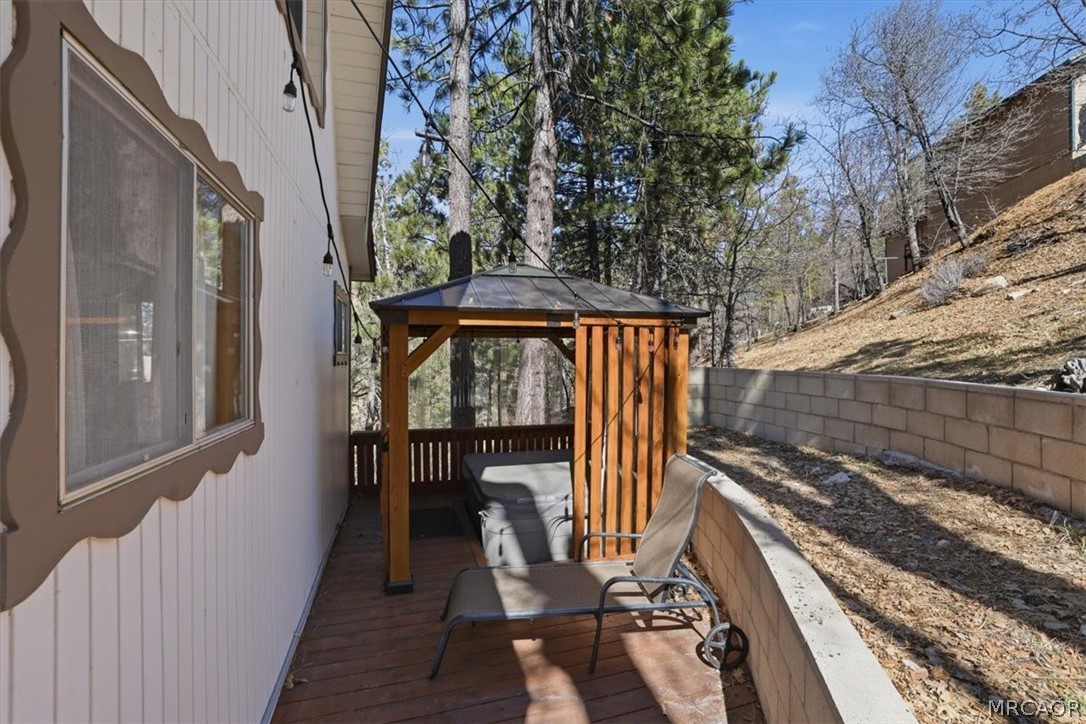 1146 Ridge Road Fawnskin, CA 92333 - Photo 32 of 34 a view of a balcony with wooden floor and outdoor seating