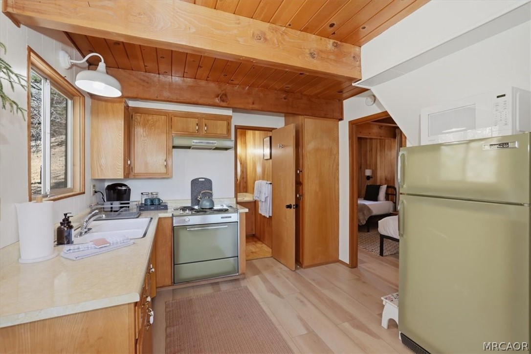 1146 Ridge Road Fawnskin, CA 92333 - Photo 10 of 34 a kitchen with a sink appliances and cabinets