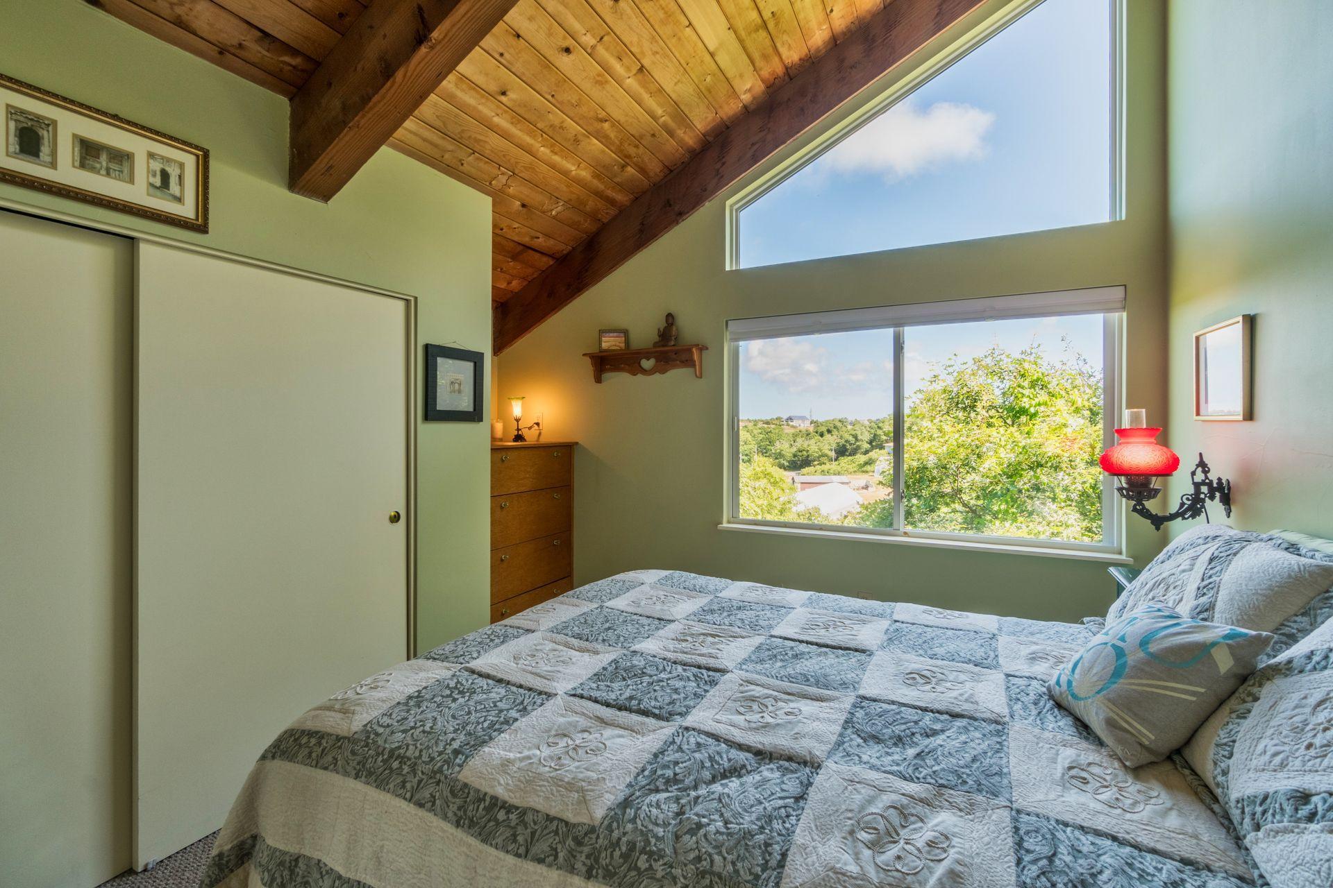 19 Resolution Road Truro, MA 02666 - Photo 21 of 32 a bedroom with a bed and a window
