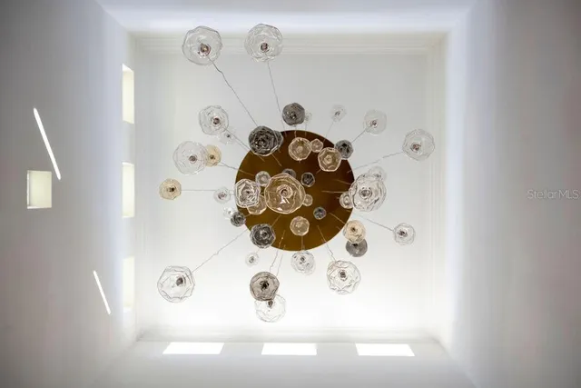 a living room with furniture large window and wooden floor