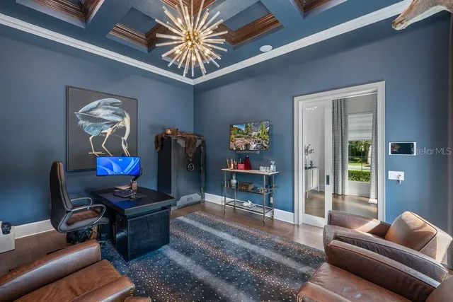 a bedroom with a large bed and a chandelier