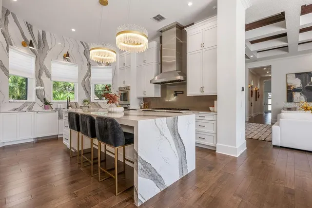 a bathroom with a granite countertop toilet sink and mirror