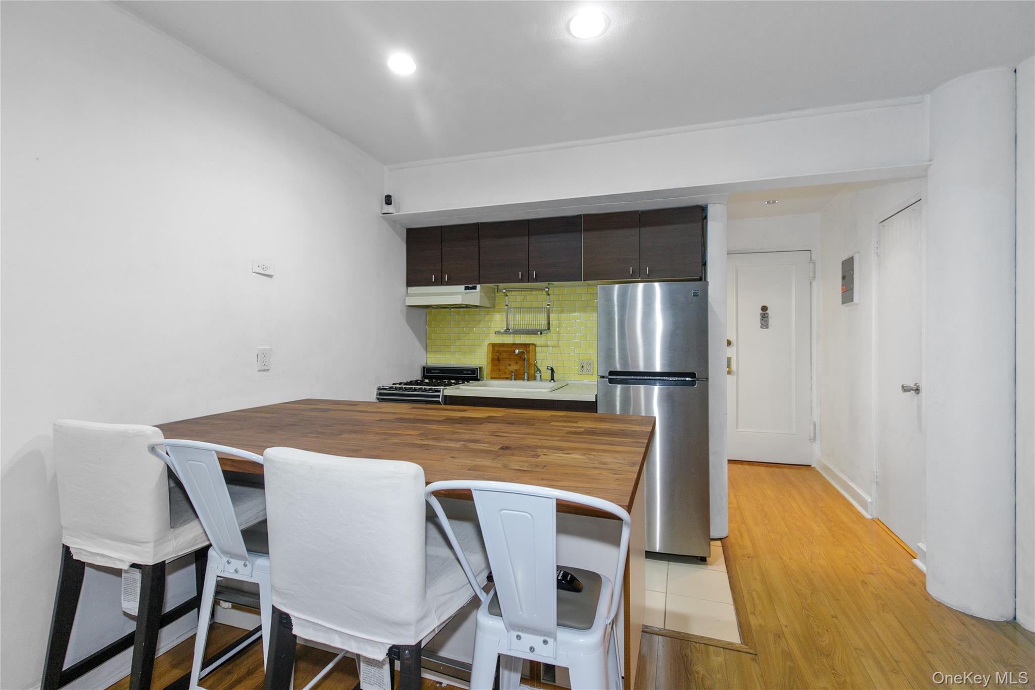 15 Canterbury Road, Unit C10 Great Neck, NY 11021 - Photo 12 of 22 a dining room with furniture and window