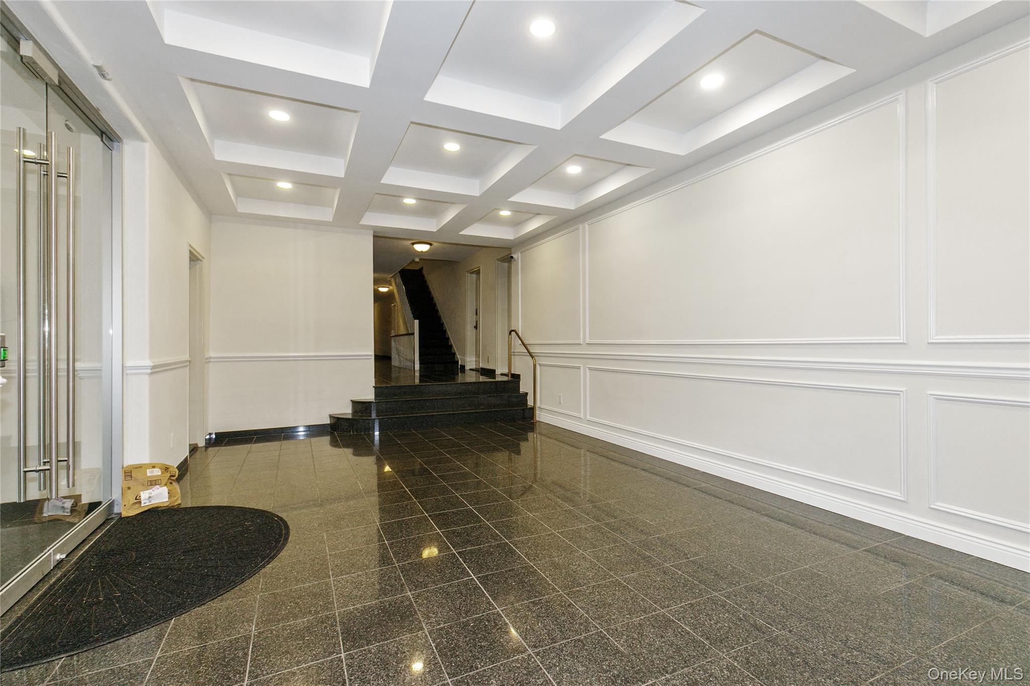 15 Canterbury Road, Unit C10 Great Neck, NY 11021 - Photo 15 of 22 a view of a hall with an entryway and couch