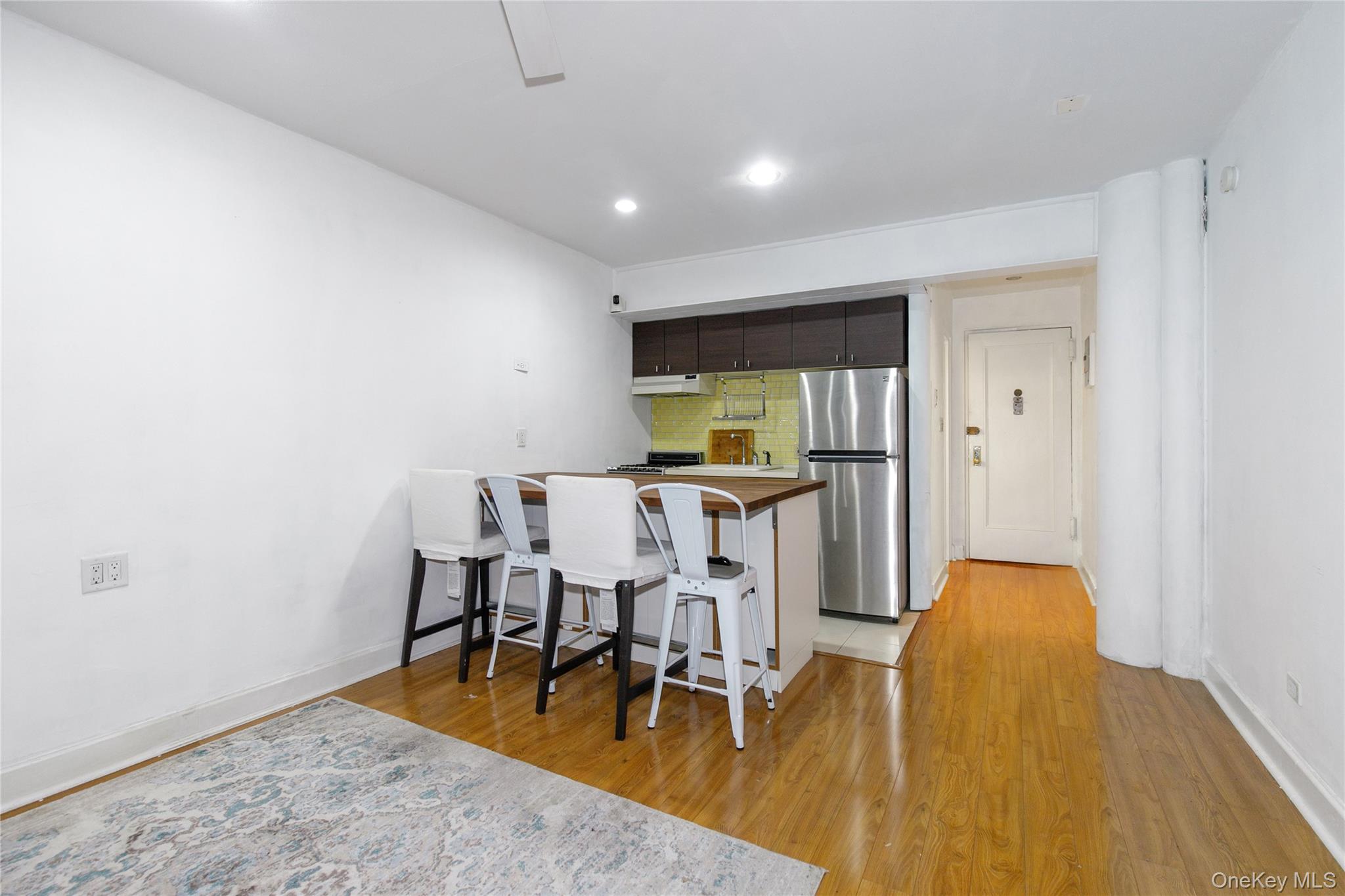 15 Canterbury Road, Unit C10 Great Neck, NY 11021 - Photo 4 of 22 a dining room with furniture and wooden floor
