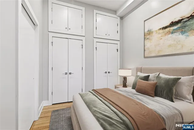 a bedroom with bed and wall painting