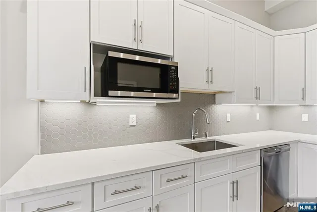 a kitchen with a sink and cabinets