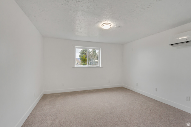 337 West 2900th Street South Bountiful, UT 84010 - Photo 28 of 35 Unfurnished room with light colored carpet and a textured ceiling