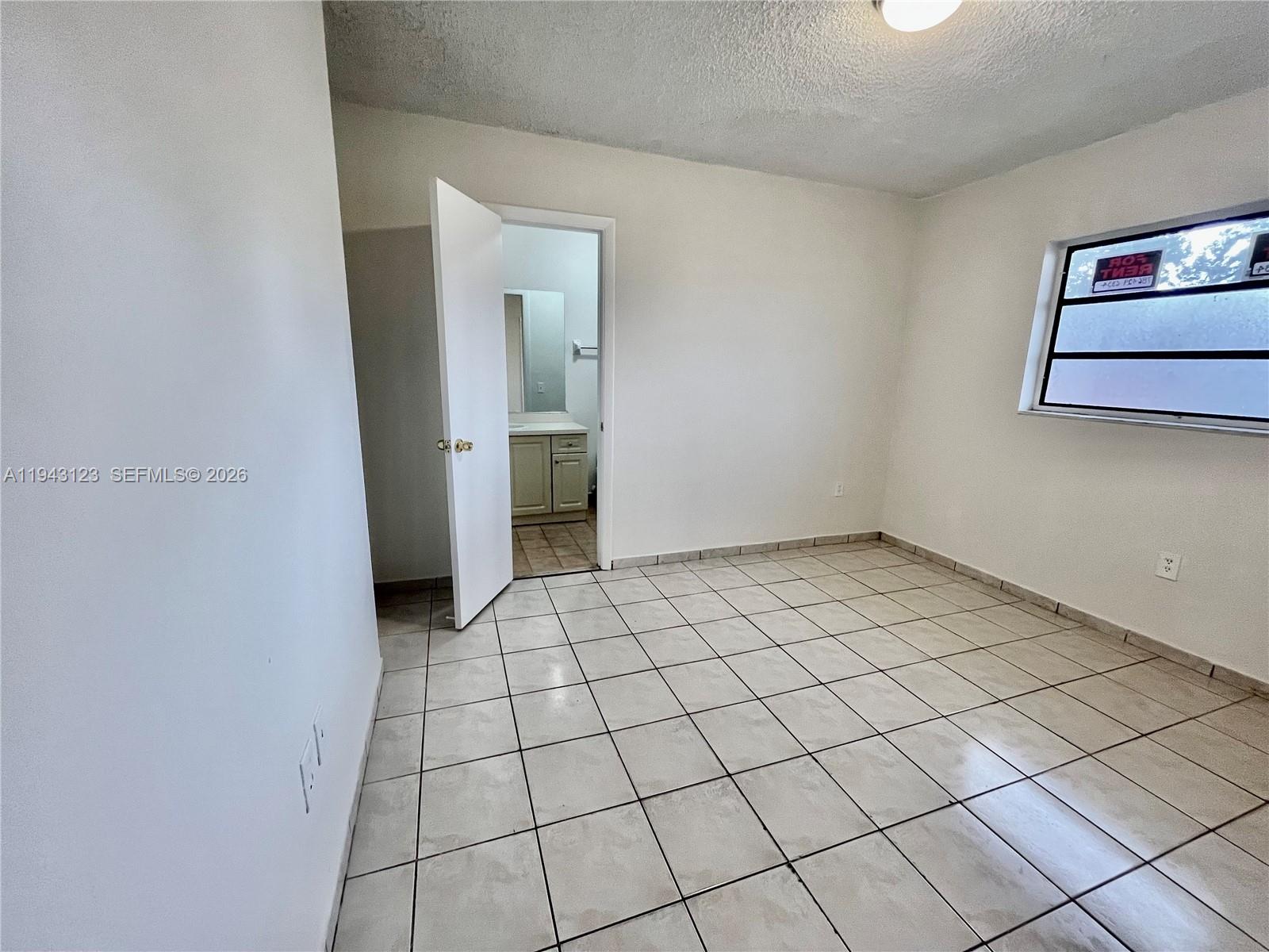 1127 West 37th Street Hialeah, FL 33012 - Photo 11 of 16 a view of an empty room and window