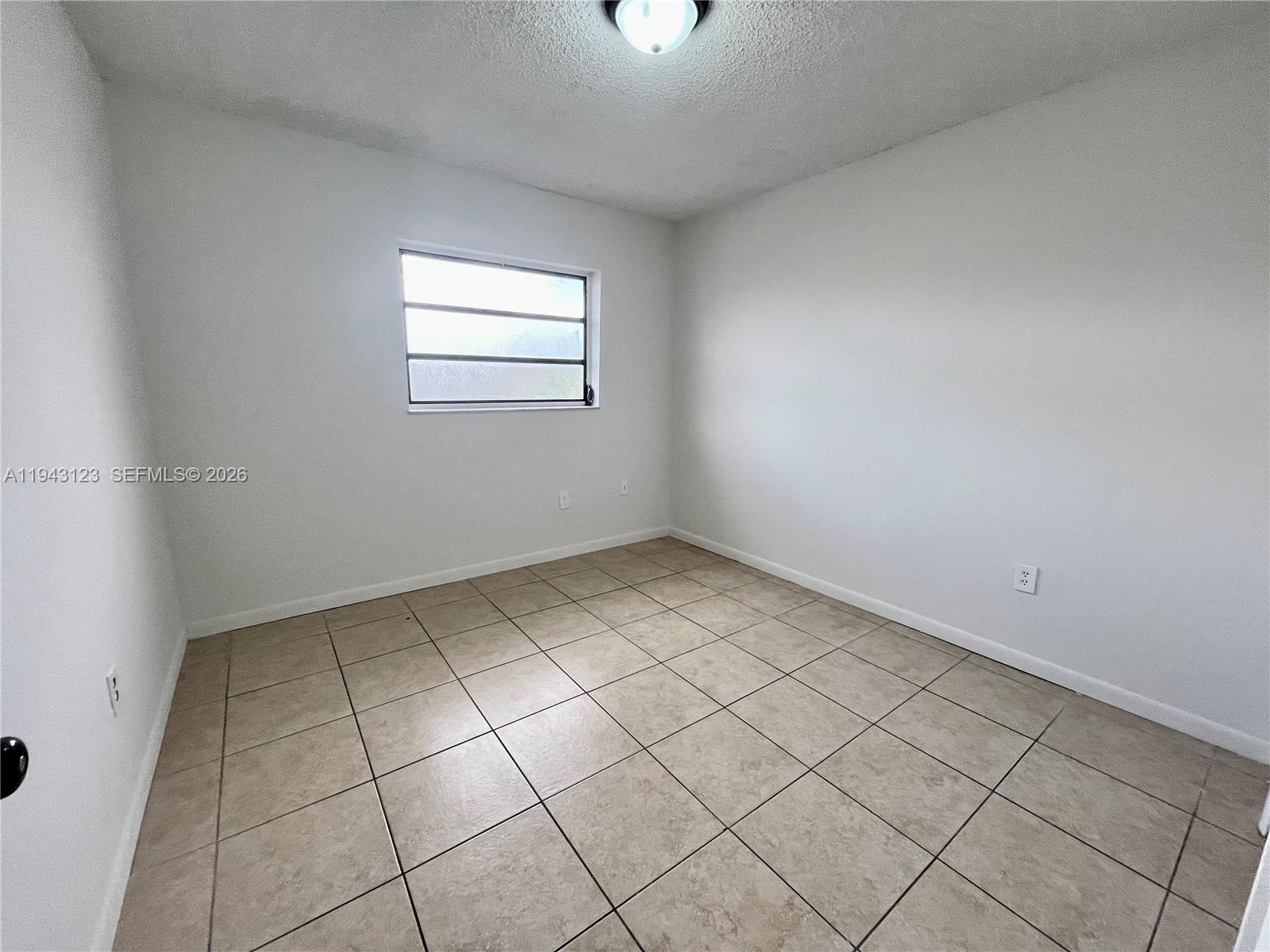 1127 West 37th Street Hialeah, FL 33012 - Photo 12 of 16 a view of a room that has a window in it