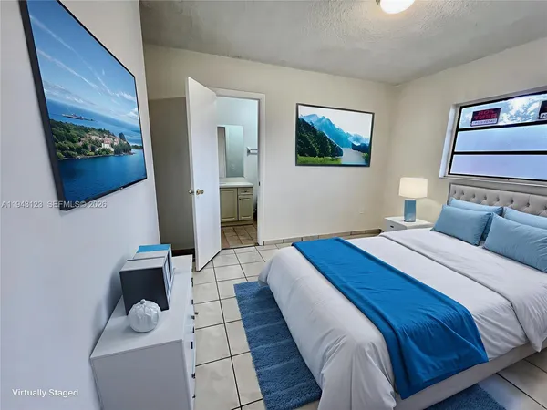 a bedroom with a large bed and a couch