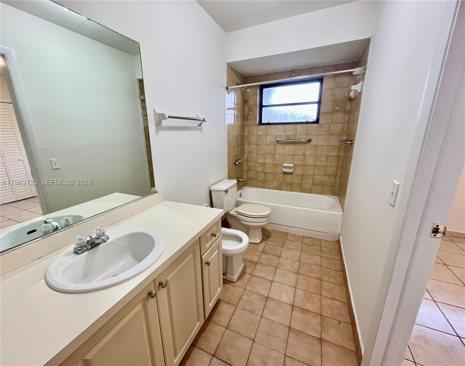 1127 West 37th Street Hialeah, FL 33012 - Photo 3 of 16 a bathroom with a sink a toilet and shower