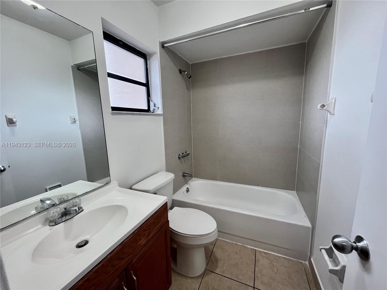1127 West 37th Street Hialeah, FL 33012 - Photo 6 of 16 a bathroom with a sink toilet and shower
