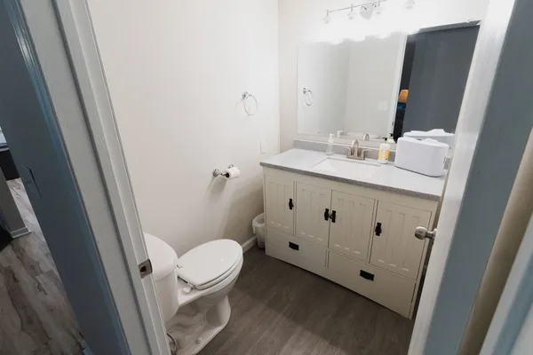 a bathroom with a sink a toilet and a mirror