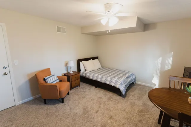a bedroom with a bed and a couch