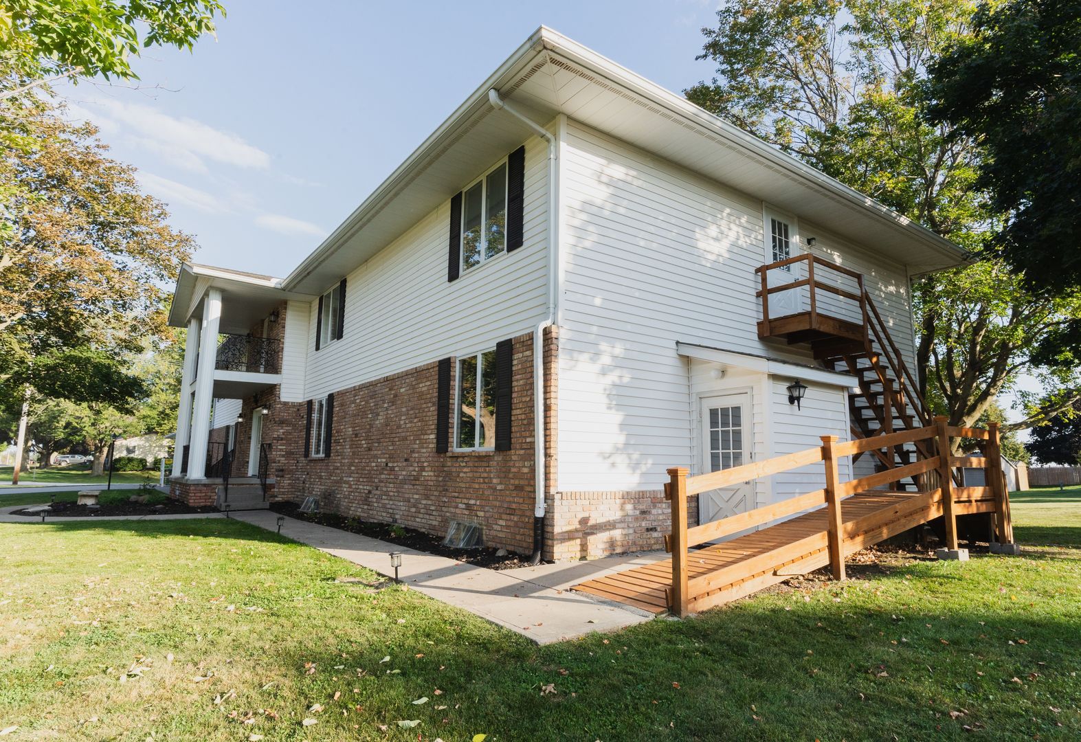 807 3rd Street Durant, IA 52747 - Photo 3 of 23 a view of a white house with a yard and sitting area