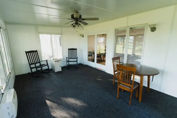 a view of a livingroom with furniture and a window
