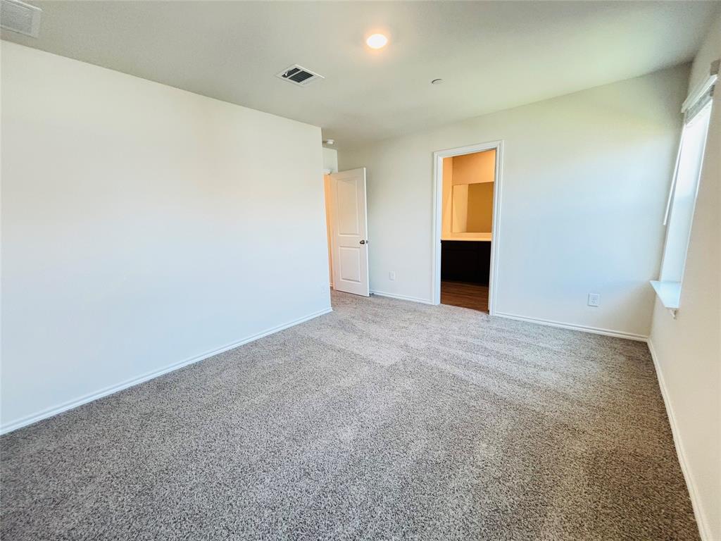 120 Redwood Road Princeton, TX 75407 - Photo 14 of 24 Spacious interior featuring neutral carpeting, white wall finishes, and a window with a deep sill