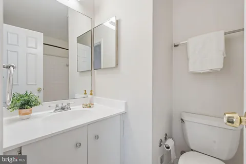 a bathroom with a sink toilet and mirror