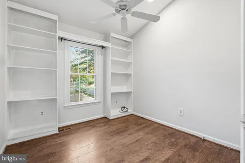 an empty room with a windows and closet