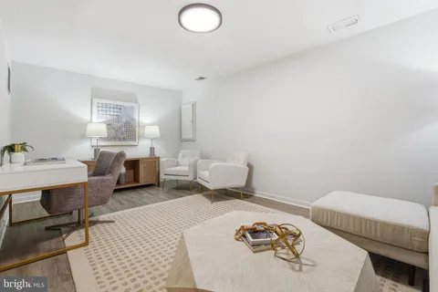 a bedroom with furniture and a wooden floor