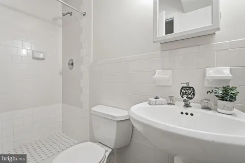 a white toilet sitting next to a bathroom sink