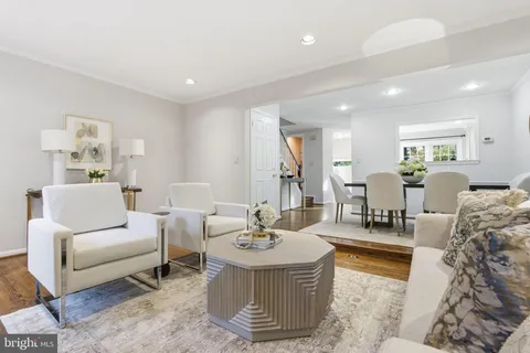 a living room with furniture and view of kitchen