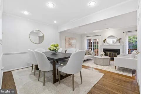 a living room with furniture a fireplace and a large window