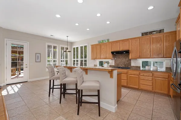 a kitchen with refrigerator and cabinets