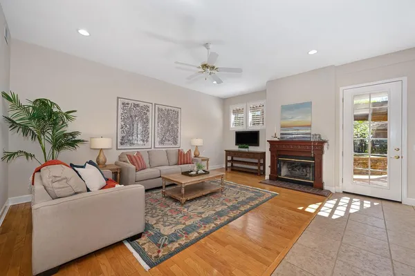 a living room with furniture and wooden floor