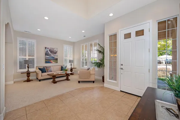 a living room with furniture and a potted plant