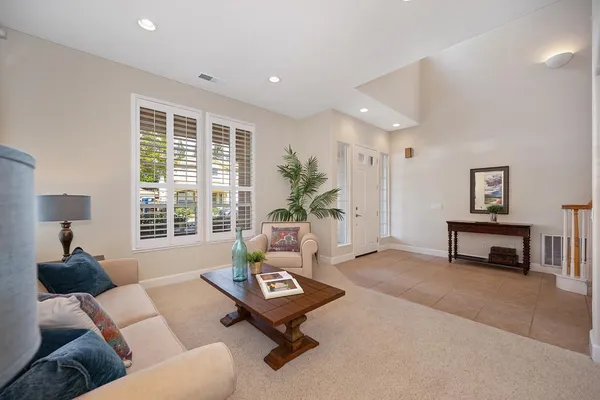 a living room with furniture and a chandelier