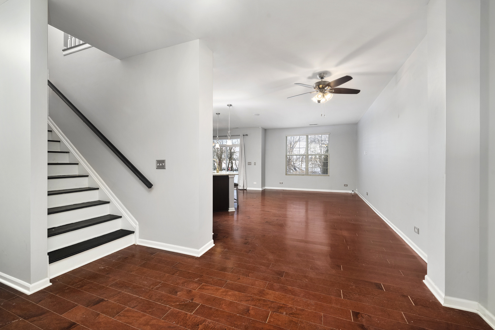 2900 Church Road Aurora, IL 60502 - Photo 2 of 15 a view of an empty room with a window and wooden floor