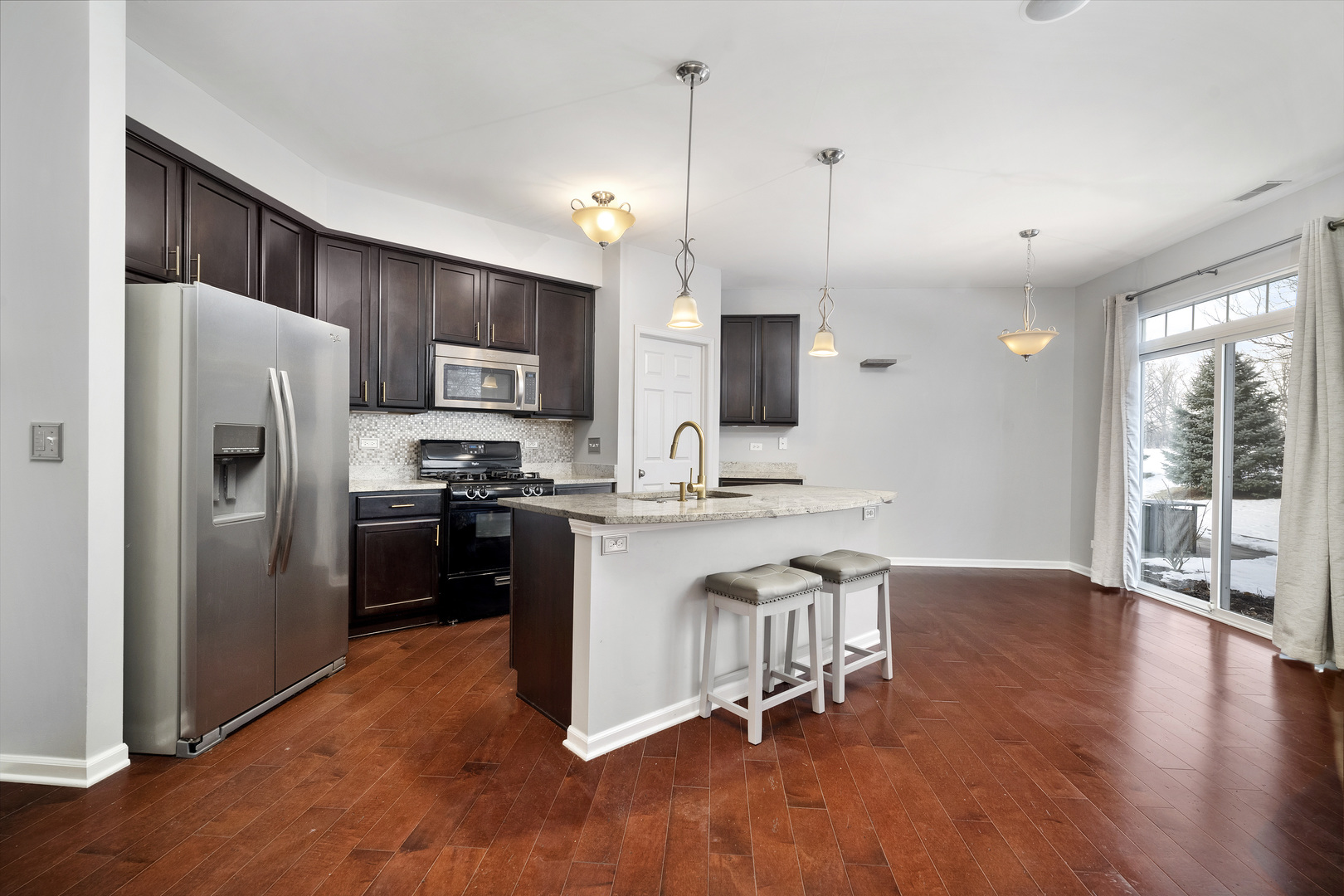 2900 Church Road Aurora, IL 60502 - Photo 4 of 15 a kitchen with stainless steel appliances a refrigerator stove a sink and a microwave
