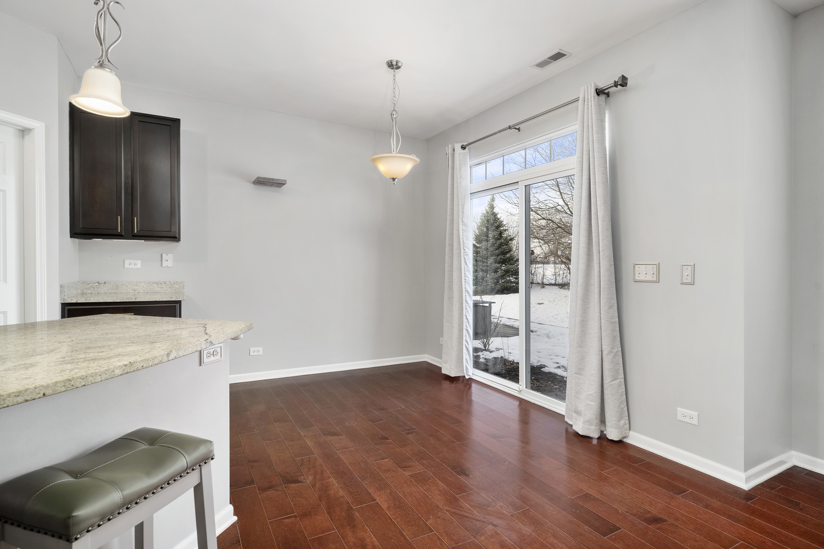 2900 Church Road Aurora, IL 60502 - Photo 6 of 15 a view of a kitchen with wooden floor and a ceiling fan