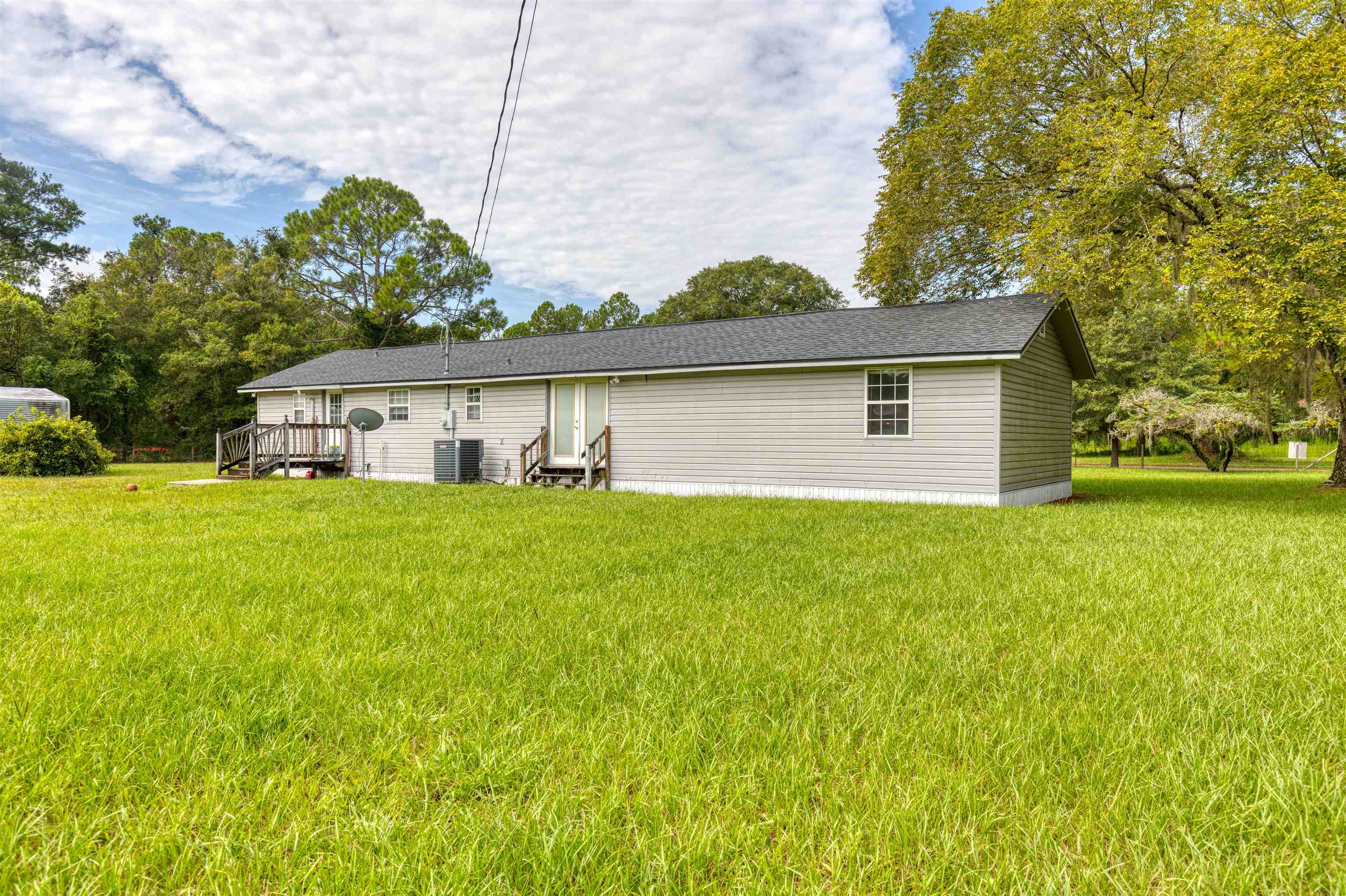 5715 Monroe Smith Road Jacksonville, FL 32210 - Photo 20 of 23 a front view of house with yard and green space