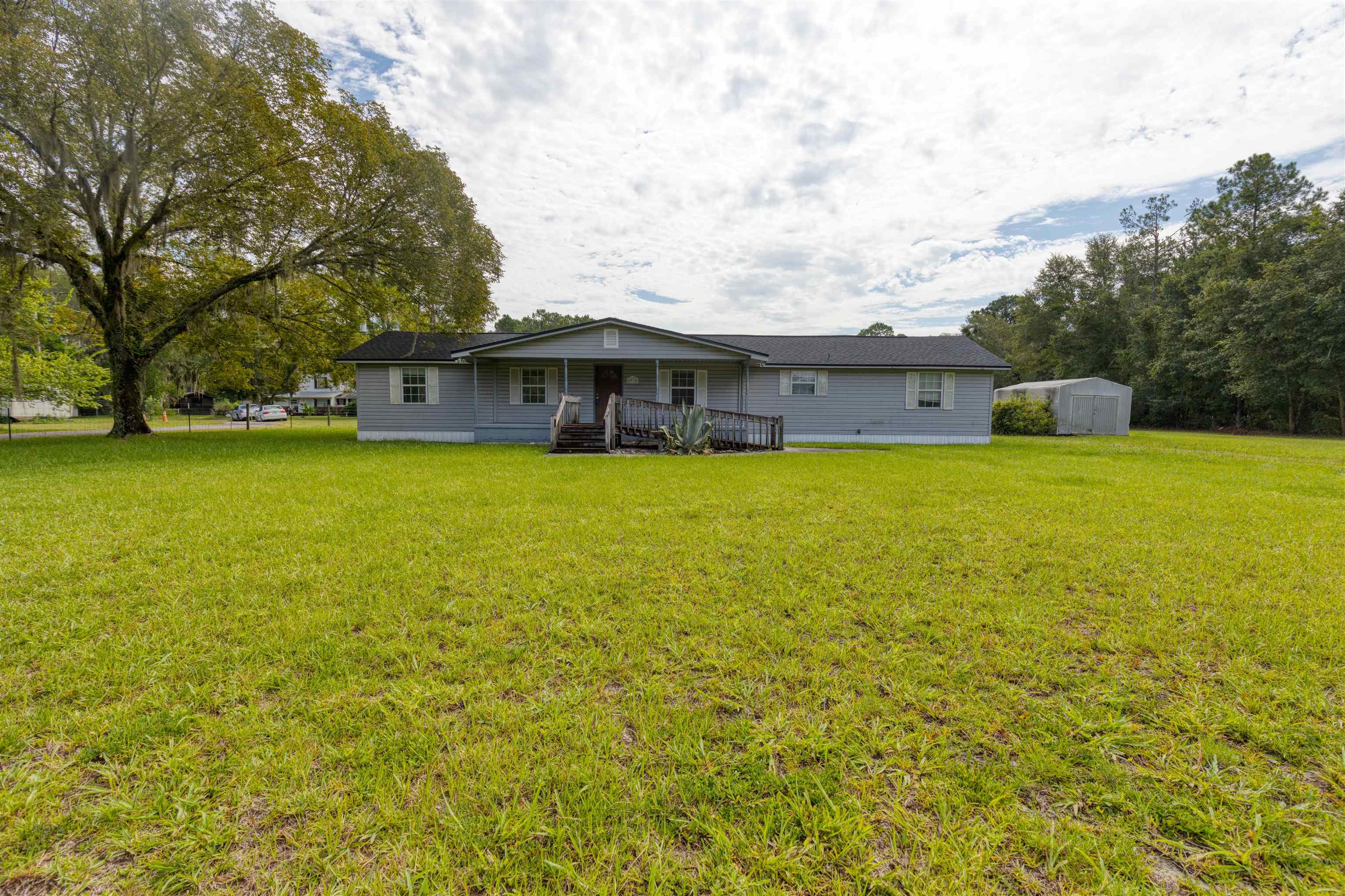 5715 Monroe Smith Road Jacksonville, FL 32210 - Photo 22 of 23 a view of a house with a garden and trees