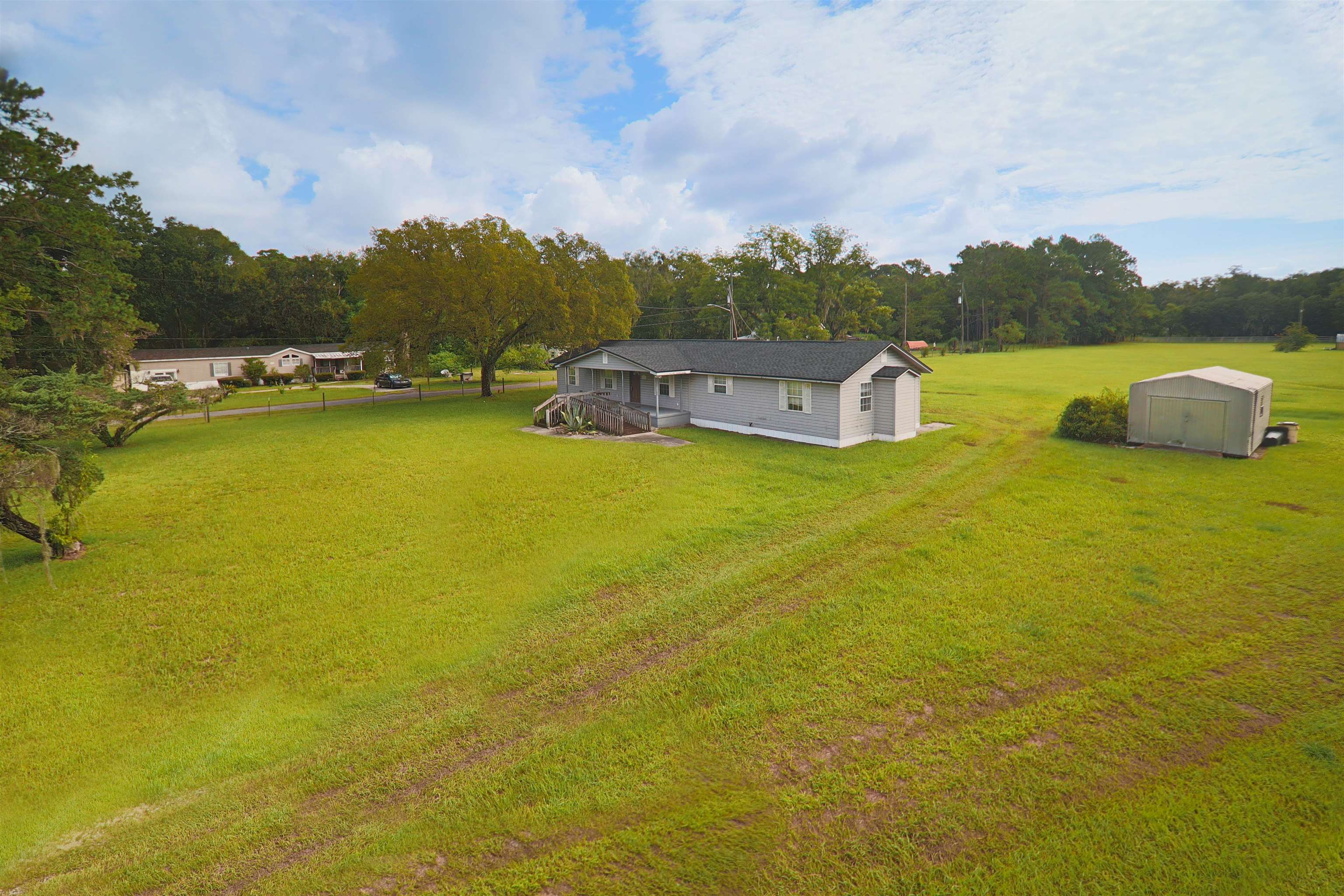 5715 Monroe Smith Road Jacksonville, FL 32210 - Photo 3 of 23 a view of a lake with houses in the background