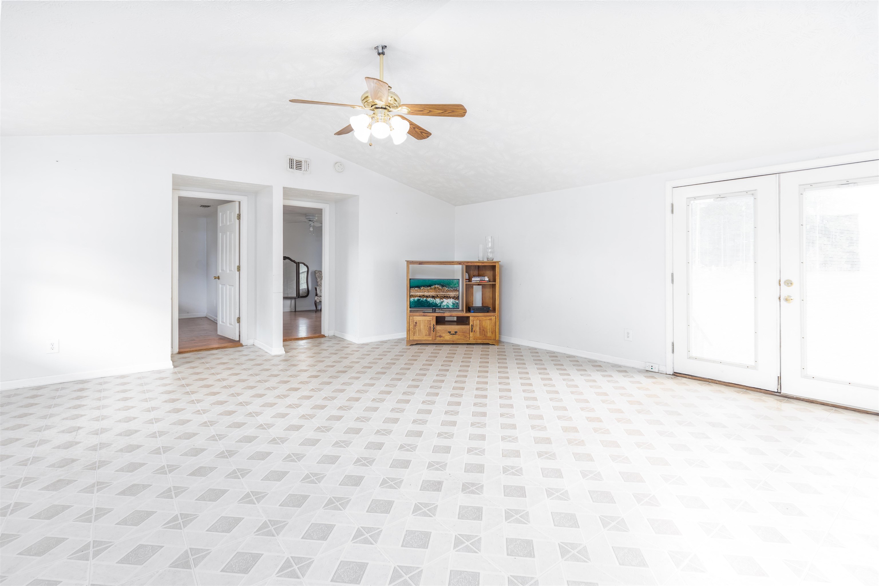 5715 Monroe Smith Road Jacksonville, FL 32210 - Photo 7 of 23 a view of a livingroom with a chandelier fan and kitchen view