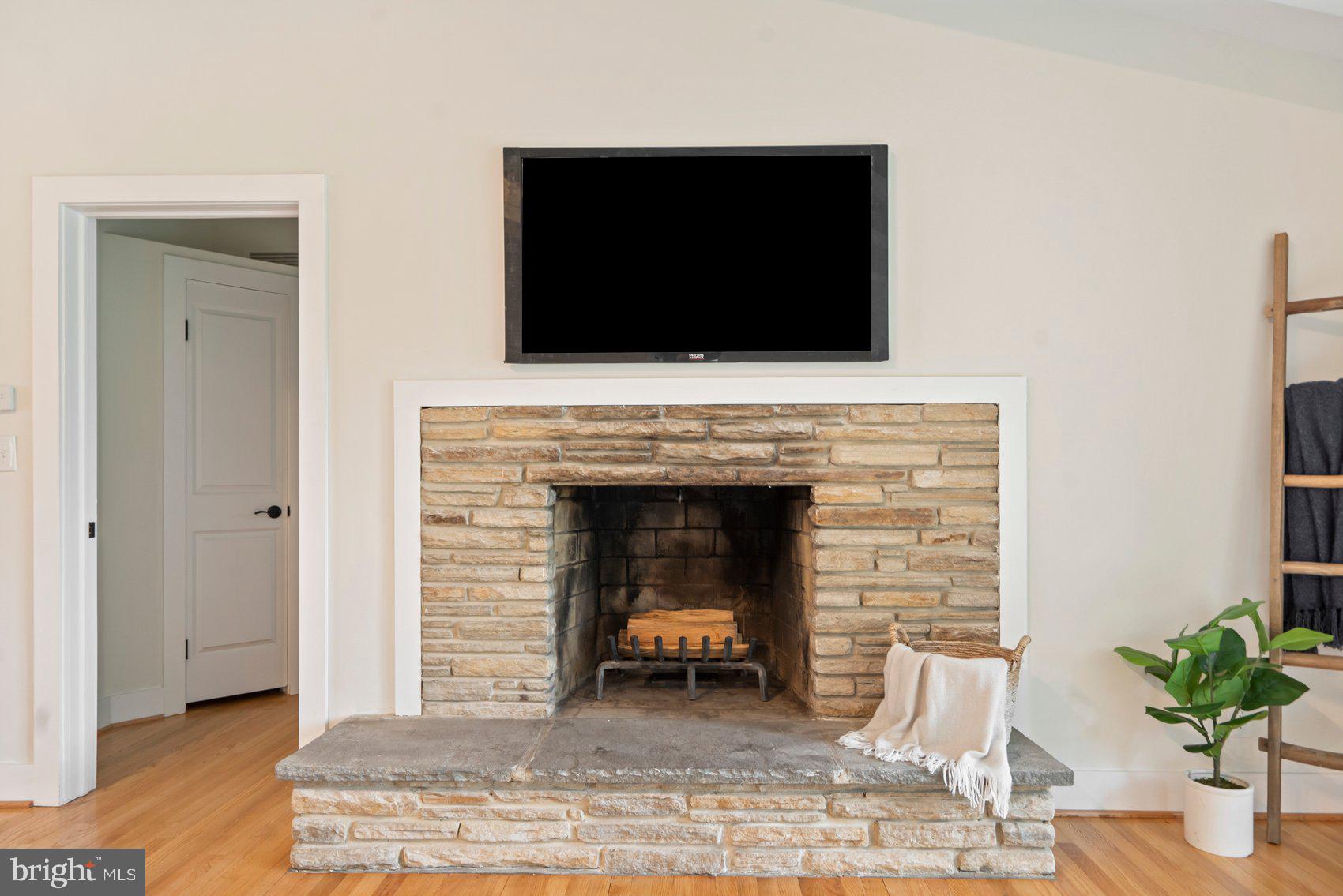 556 Valley View Road Towson, MD 21286 - Photo 12 of 43 a living room with a fireplace and a flat screen tv