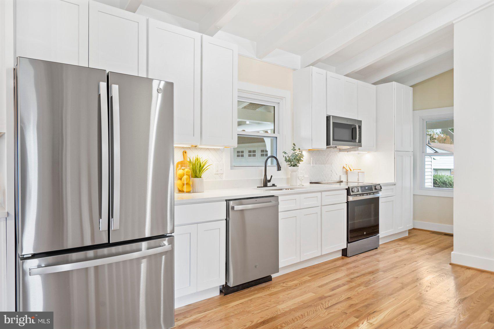 556 Valley View Road Towson, MD 21286 - Photo 17 of 43 a kitchen with a refrigerator and a sink