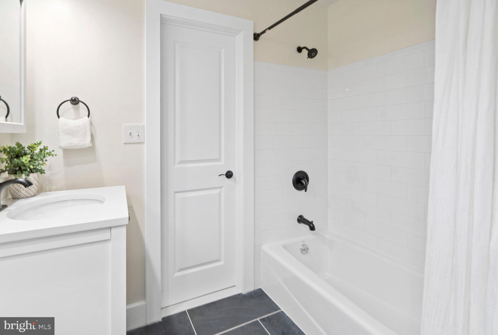 556 Valley View Road Towson, MD 21286 - Photo 26 of 43 a bathroom with a bathtub a sink a toilet and a shower
