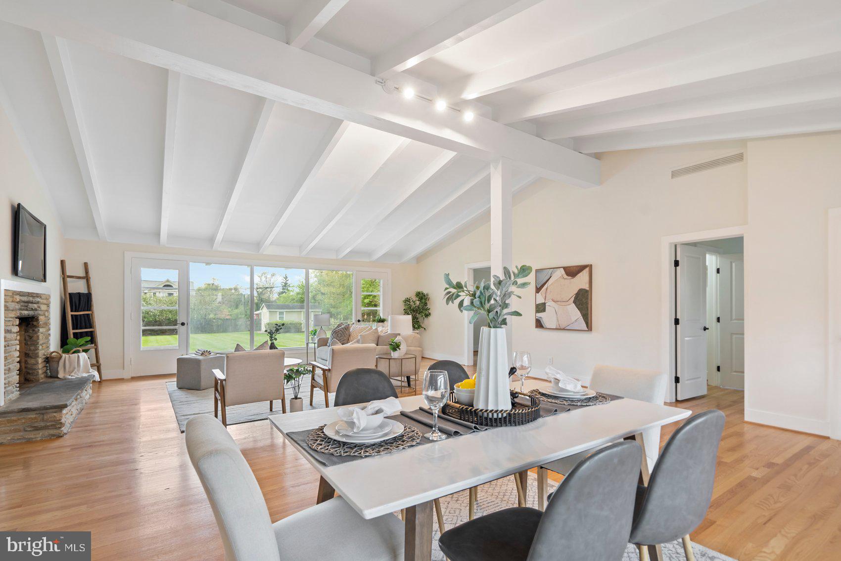556 Valley View Road Towson, MD 21286 - Photo 5 of 43 a view of a dining room with furniture large windows and wooden floor