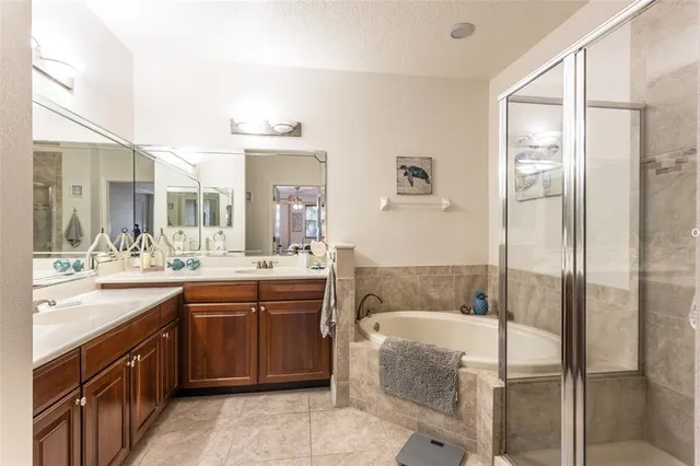 a spacious bathroom with a granite countertop sink mirror and bathtub